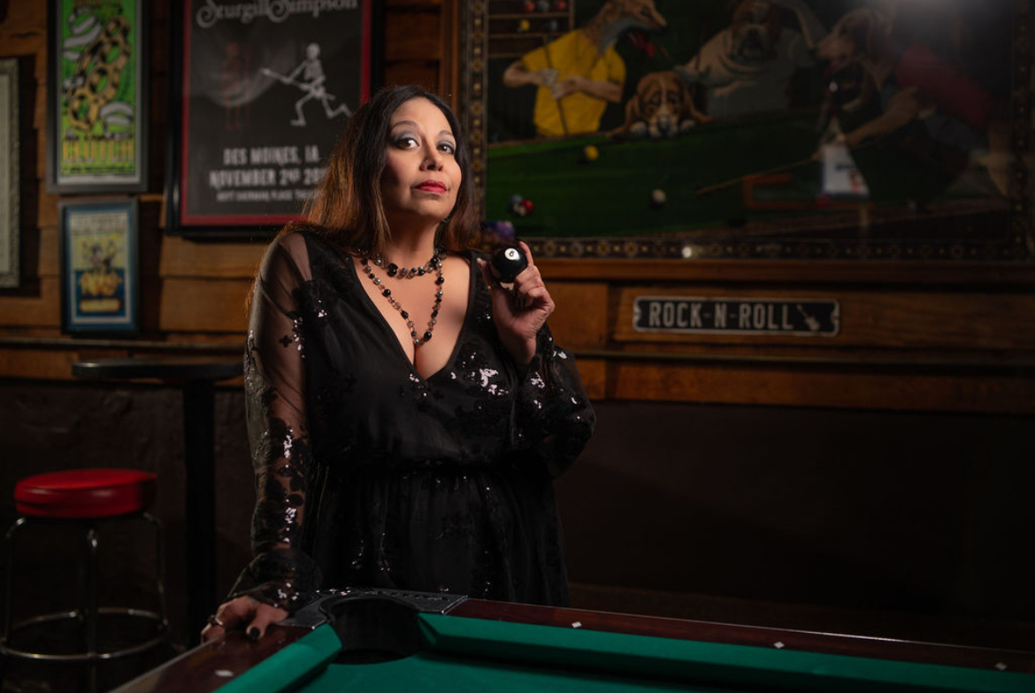 A friend singing into a microphone during a themed photo shoot