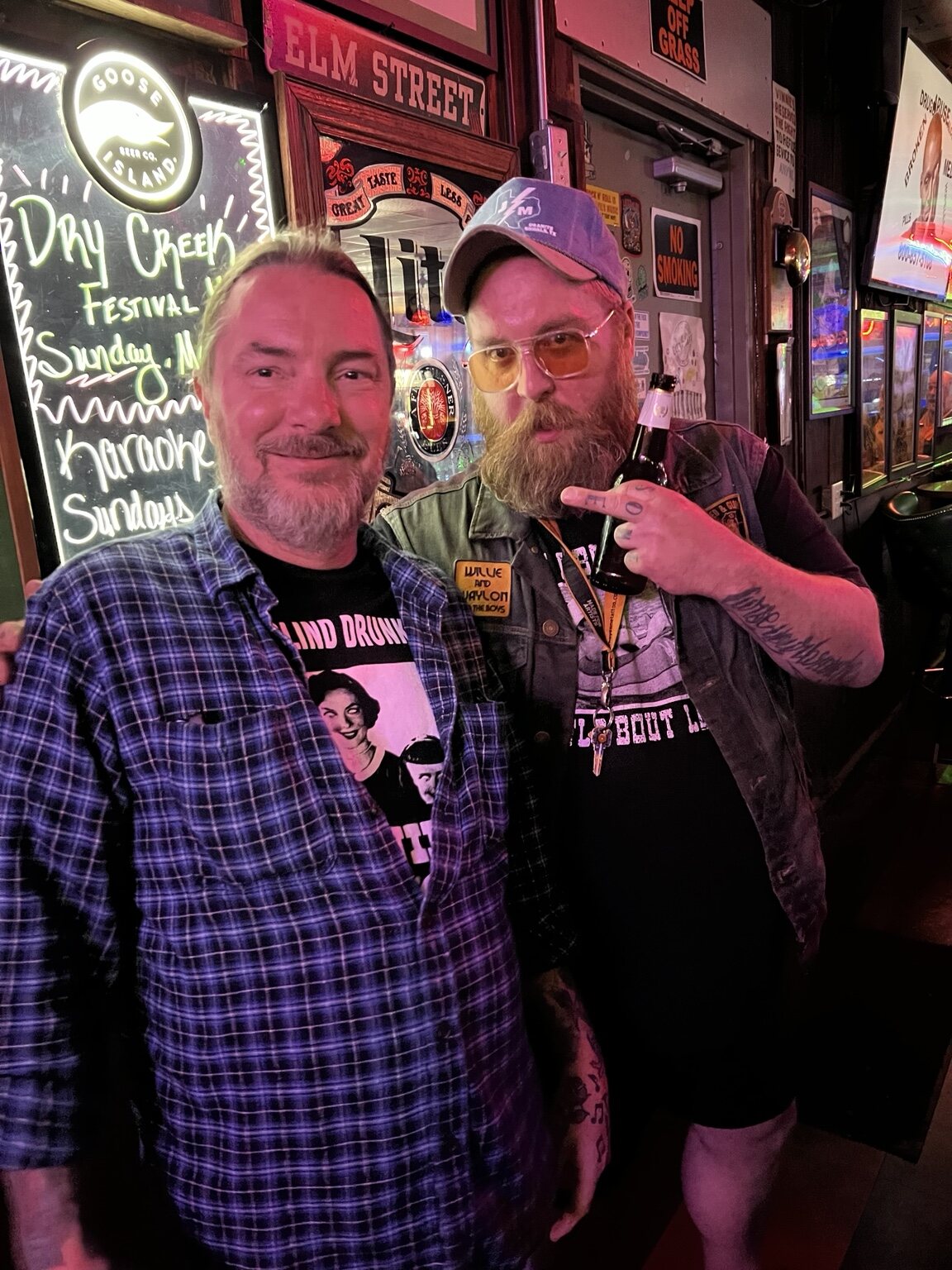 Two friends posing together inside Vinnie's
