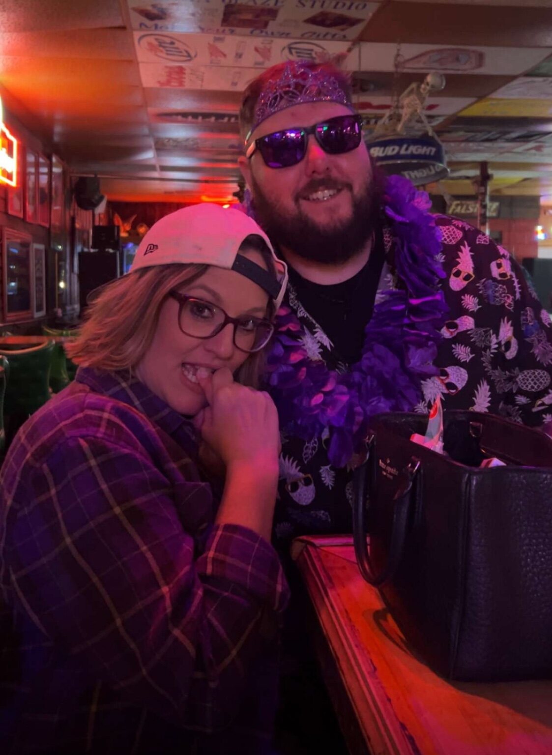 Two friends striking a playful pose at the bar