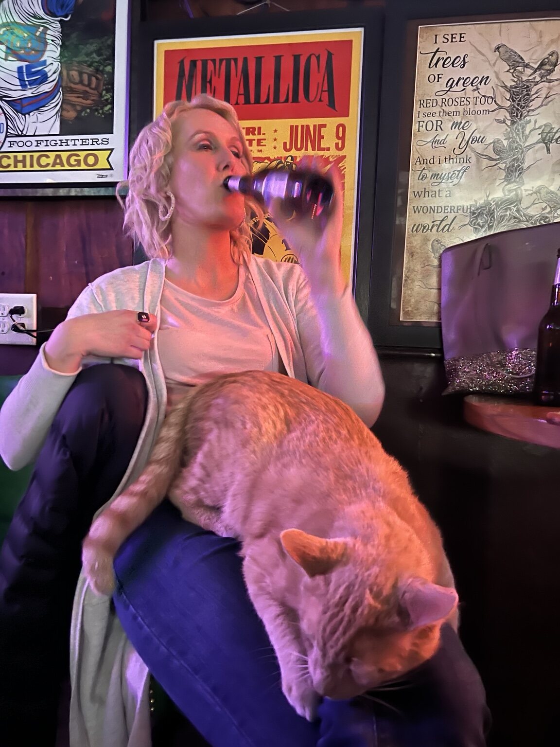 A Vinnie's friend with Chico the bar cat across her lap