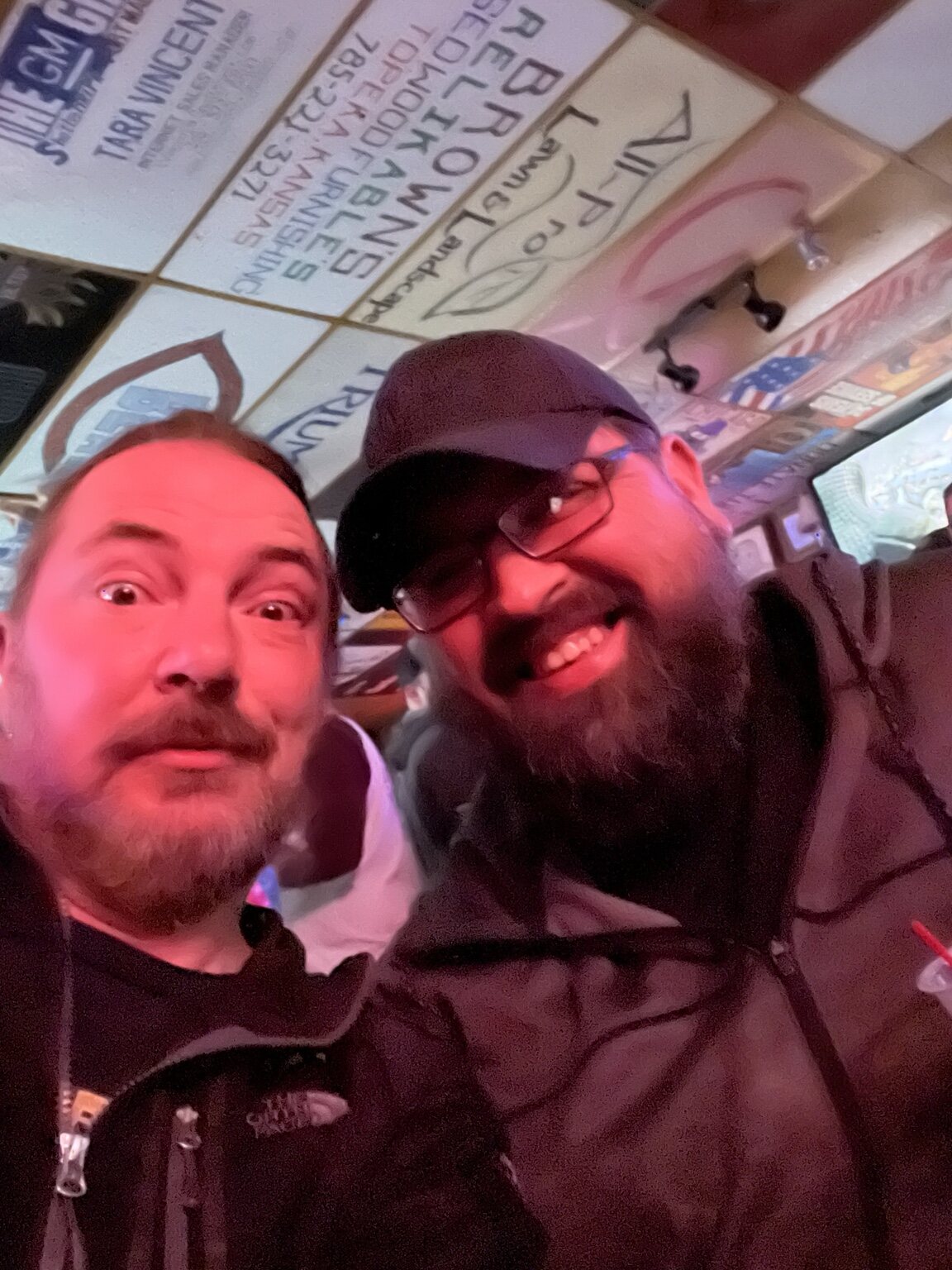 Two friends taking a goofy close-up selfie